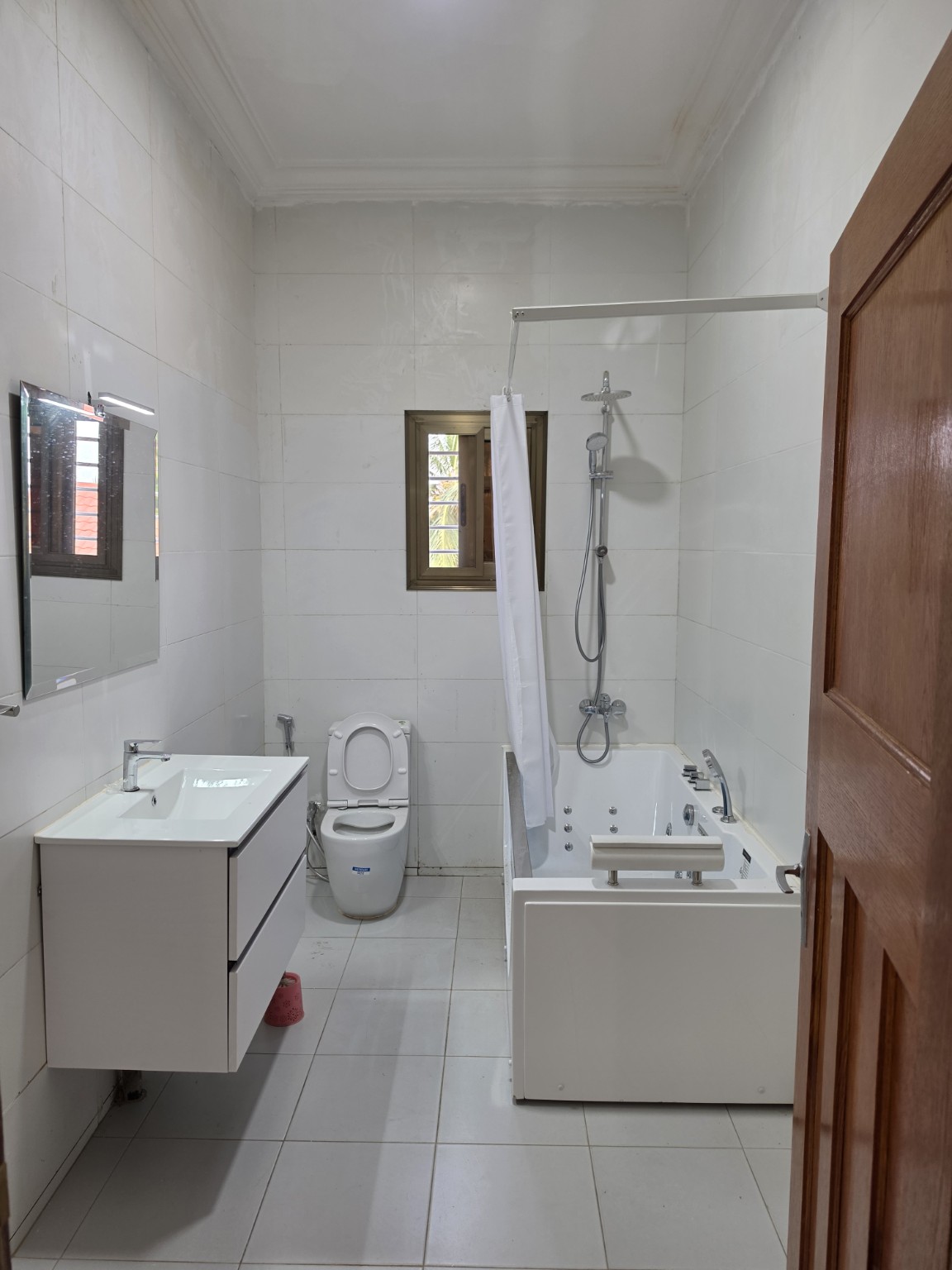 Modern bathroom with jacuzzi bath, shower and vanity